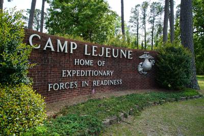 Signage stands on the main gate to Marine Corps Base Camp Lejeune outside Jacksonville, N.C., Friday, April 29, 2022.