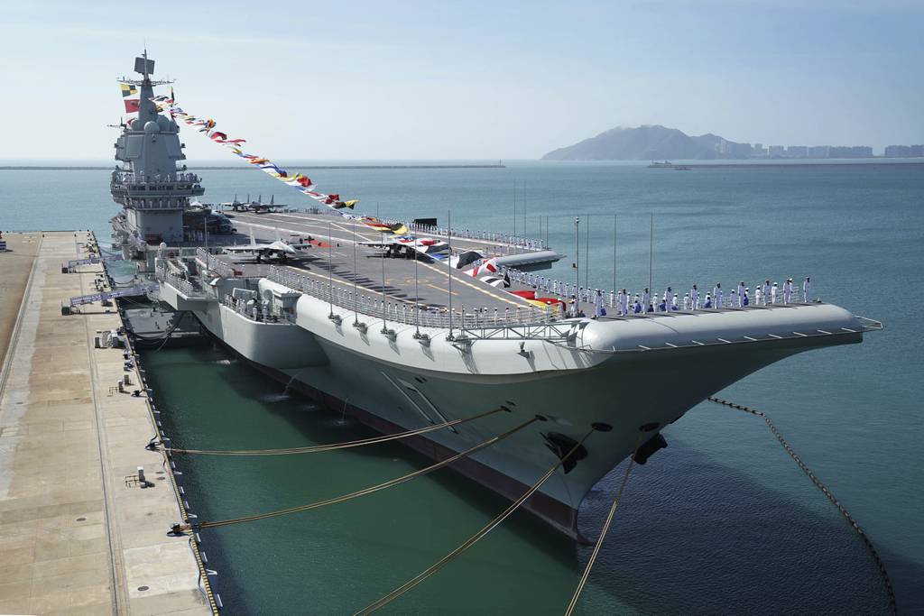 In this Dec. 17, 2019, file photo provided by Xinhua News Agency, the Shandong aircraft carrier is docked at a naval port in Sanya in southern China's Hainan Province.
