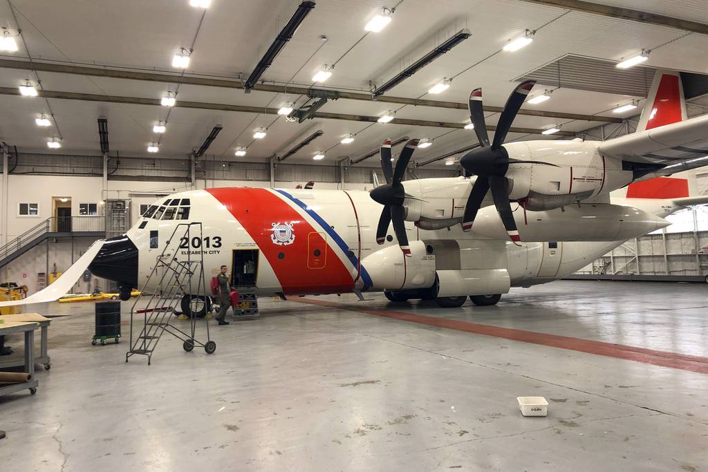 In this image provided by the U.S. Coast Guard, crew members prepare to depart from St. John's, Newfoundland, Canada, on a Coast Guard HC-130 Hercules airplane to help in the search for the 21-foot submersible, Titan, Wednesday, June 21, 2023.