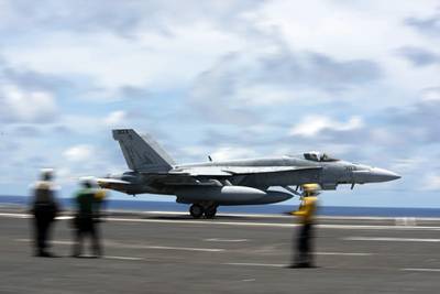 An F/A-18E Super Hornet practices a touch-and-go maneuver on the flight deck of the aircraft carrier USS Ronald Reagan (CVN 76) on June 10, 2020, in the Philippine Sea.