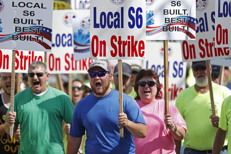 In this July 25, 2020 file photo, striking Bath Iron Works shipbuilders march in solidarity in Bath, Maine.