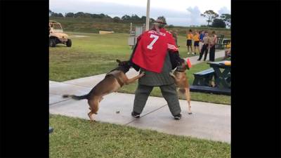 An image made from a video posted on Twitter shows a man wearing a Colin Kaepernick jersey during a K-9 demonstration at the Navy SEAL Museum in Florida.