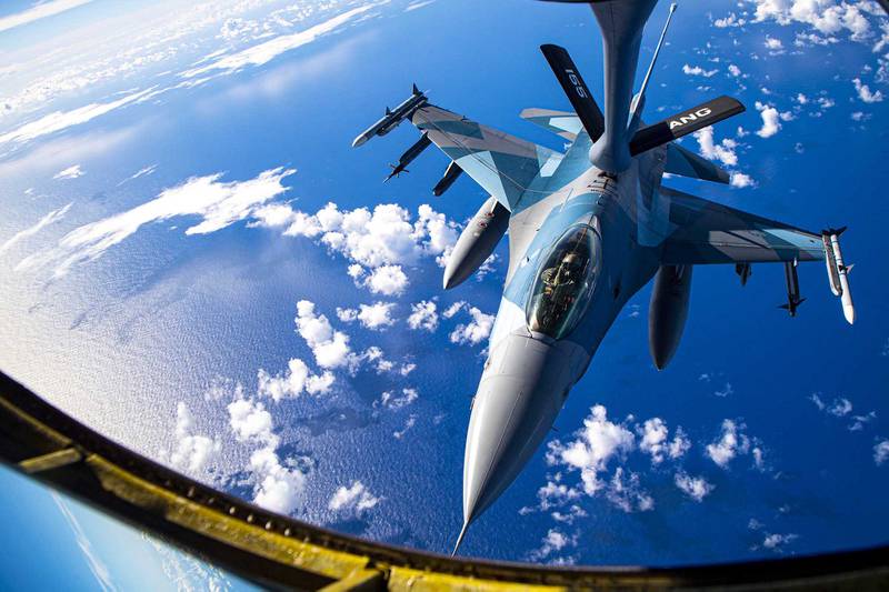 An Air Force F-16 Fighting Falcon conducts an aerial refueling with an Air Force KC-135 Stratotanker during exercise Cope North 21 near Andersen Air Force Base, Guam, Feb. 18, 2021.