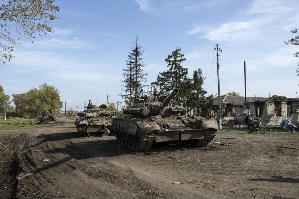 Abandoned Russian tanks stand on the road in recently liberated town Kupiansk, Ukraine, on Oct. 1, 2022.