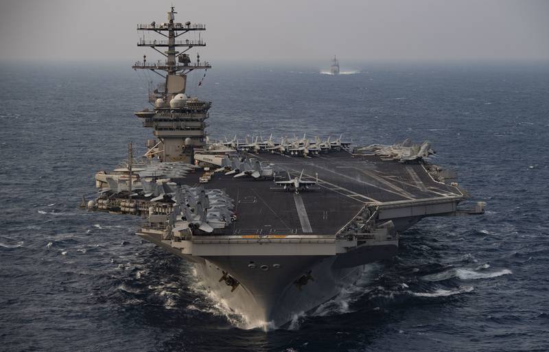 The aircraft carrier USS Nimitz (CVN 68) steams ahead of the guided-missile cruiser USS Princeton (CG 59) while participating in Malabar 2020 in the north Arabian Sea on Nov. 17, 2020.