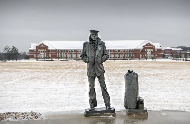 The statue of the Lone Sailor stands on the snow-covered grounds of Recruit Training Command at Great Lakes, Ill., on Dec. 30, 2020.
