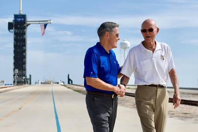 In this Tuesday, July 16, 2019 photo made available by NASA, astronaut Michael Collins, right, speaks to Kennedy Space Center Director Bob Cabana at Launch Complex 39A, about the moments leading up to launch at 9:32 a.m. on July 16, 1969, and what it was like to be part of the first mission to land on the moon.