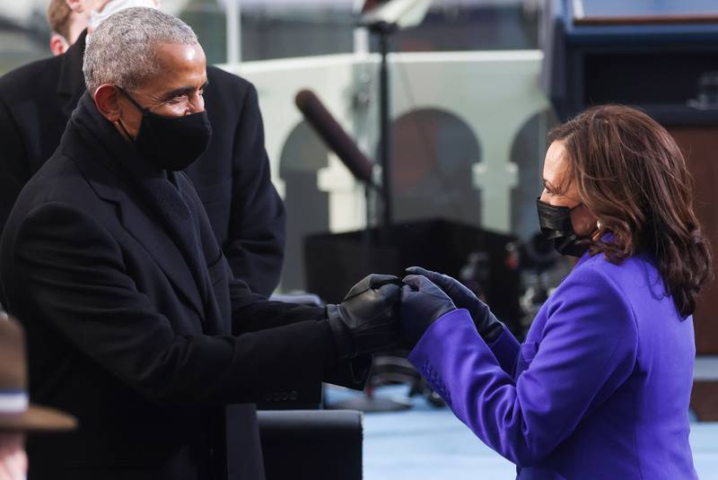 Former President Barack Obama, left, bumps fists with Vice President-elect Kamala Harris as they arrive for the inauguration of Joe Biden as the 46th president on the West Front of the Capitol in Washington on Jan. 20, 2021.