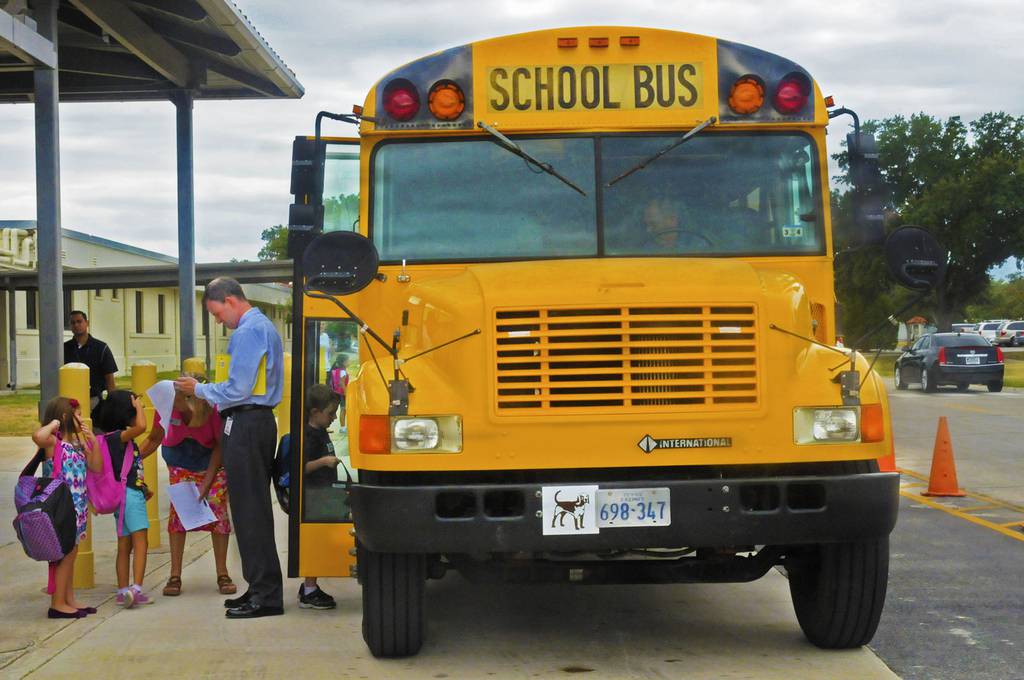 William Woodland, Randolph elementary school associate principle, ensures the children get on the right bus Aug. 27, 2013, in front of the elementary school at Joint Base San Antonio-Randolph in Texas.