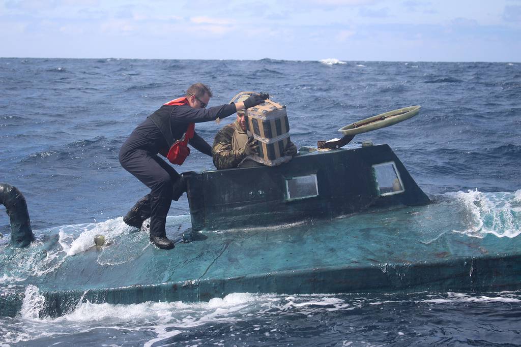 Coast Guard members board a narco semi-submersible