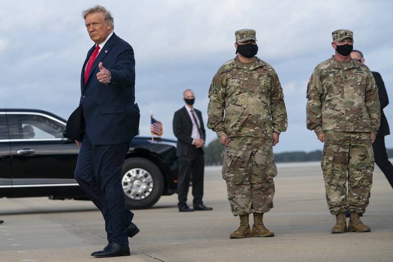 President Donald Trump gives a thumbs up after arriving at Pope Army Field for an event with troops at Fort Bragg, Thursday, Oct. 29, 2020, in Pope Field, N.C.