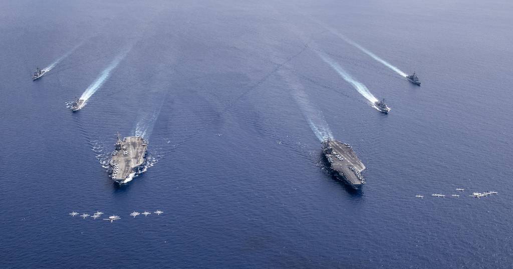 Aircraft from Carrier Air Wings (CVW) 5 and 17 fly in formation over the Nimitz Carrier Strike Force on July 6, 2020, in the South China Sea.
