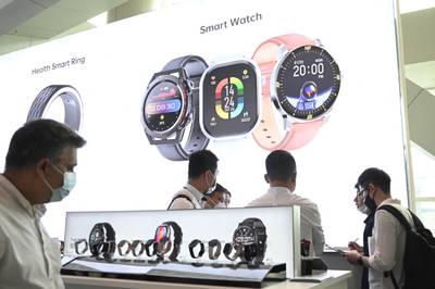 Visitors look at smart watches at the Hong Kong Electronics Fair at the Hong Kong Convention and Exhibition Centre on April 12, 2023.