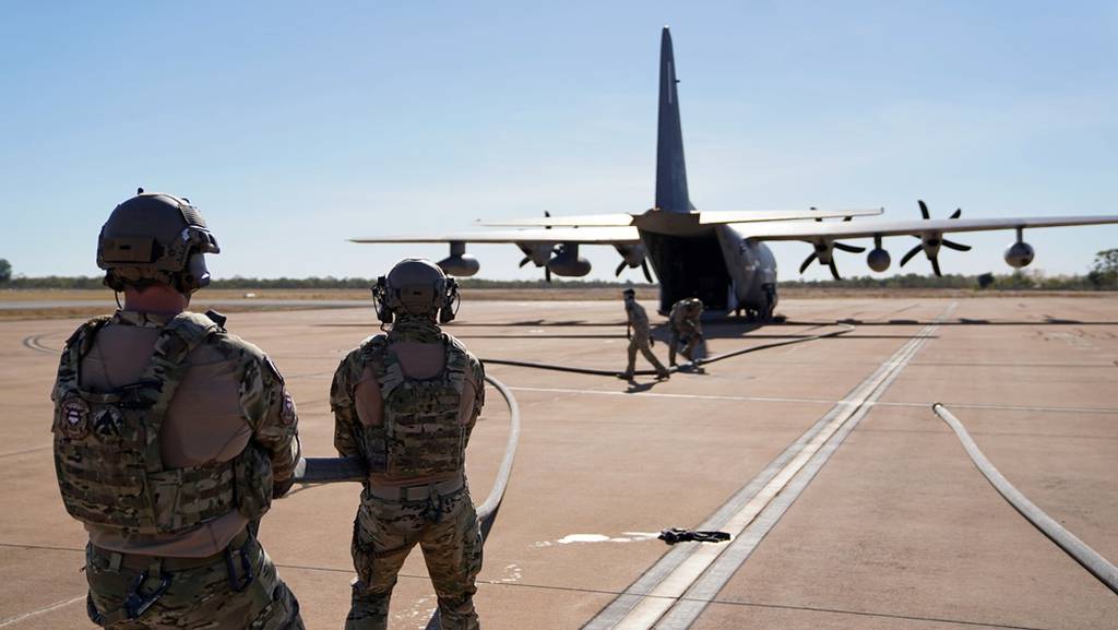 Forward Area Refueling Point specialists align fuel hosing between a U.S. MC-130J Air Commando II and an Australian C-130J Hercules during Talisman Sabre 21 at Royal Australian Air Force Base Tindal in Australia's Northern Territory on July 22, 2021. This was the first time an Australian aircraft was refueled by a U.S. aircraft via a FARP. Australian and U.S. Forces combine biennially for Talisman Sabre; a month-long multi-domain exercise that strengthens allied and partner capabilities to respond to the full range of Indo-Pacific security concerns. (1st Lt. Joshua Thompson/Air Force)