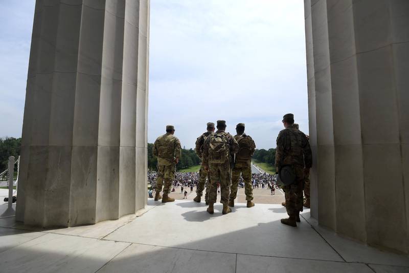 Soldiers with the Mississippi Army National Guard's 1st Battalion, 155th Infantry Regiment watch from the Lincoln Memorial as demonstrators peacefully gather in front of the memorial during protests in Washington, D.C., Saturday, June 6, 2020, in the wake of the death of George Floyd.