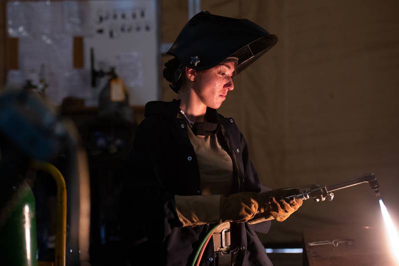 Staff Sgt. Natalie Delgado, an aircraft metals technician deployed to the 332d Air Expeditionary Wing, lights a torch preparing to cut metal on Sept. 24, 2020, in an undisclosed location.