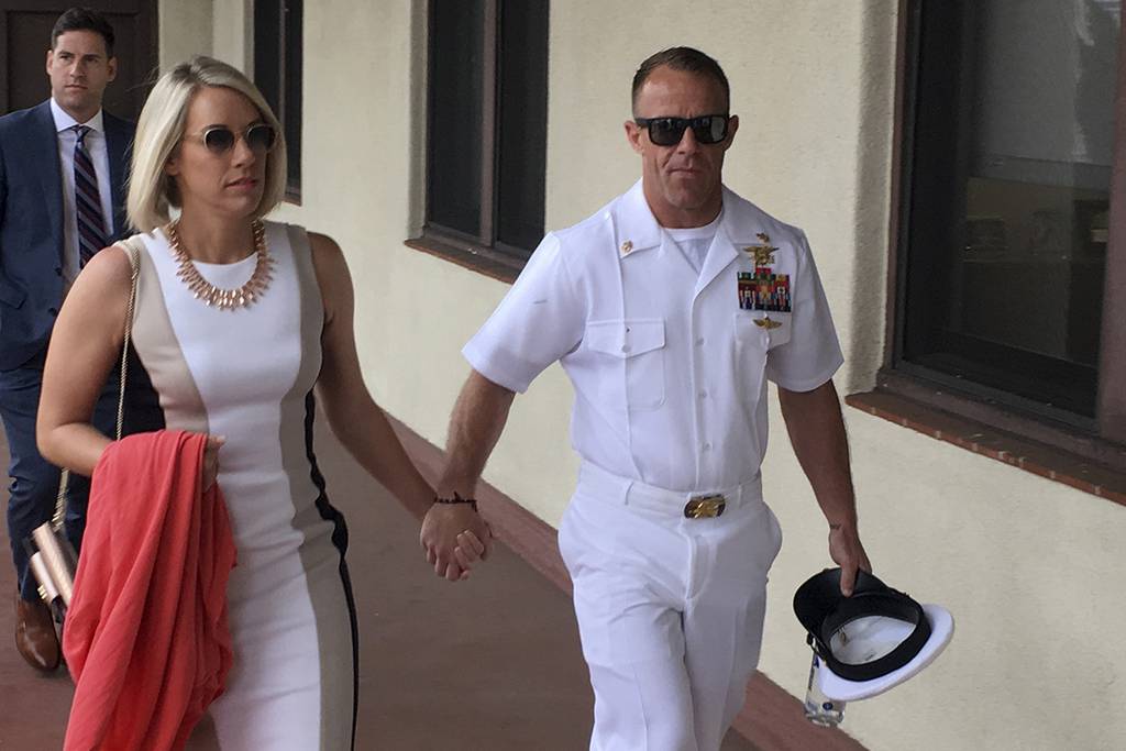 Navy Special Operations Chief Edward Gallagher, right, walks with his wife, Andrea Gallagher as they arrive to military court on Naval Base San Diego