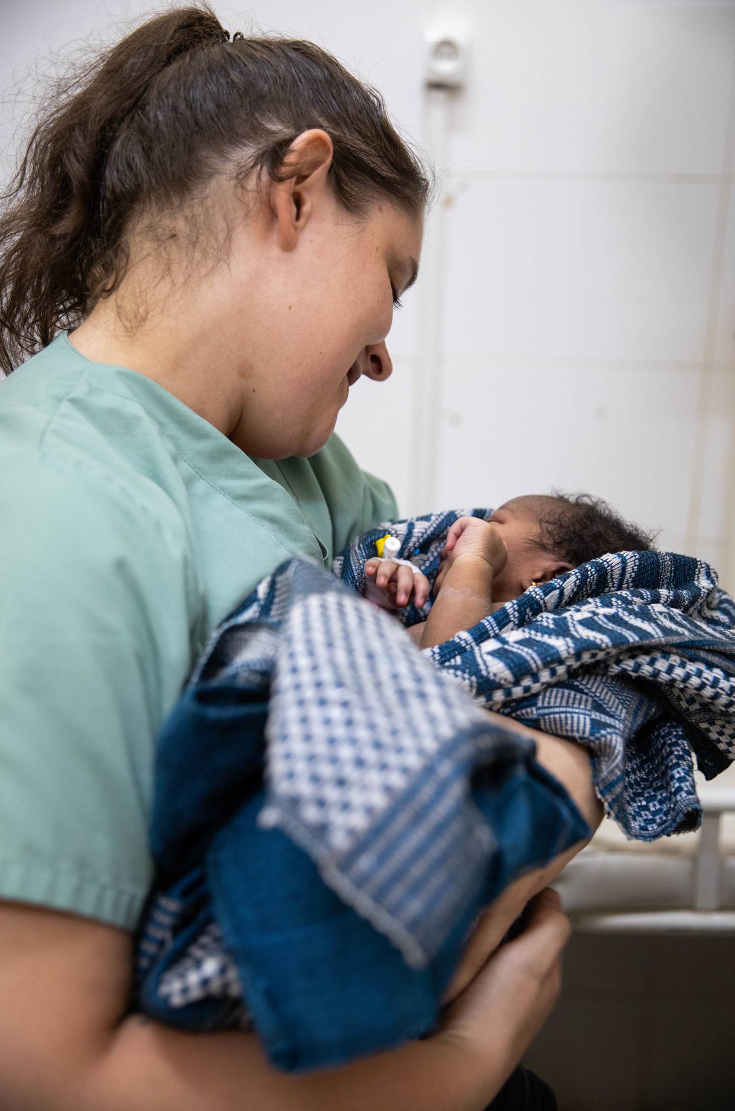 Army Staff Sgt. Christina Fontaine, a doula with the Vermont National Guard, soothes a days-old newborn in February during a medical readiness exercise in Senegal.