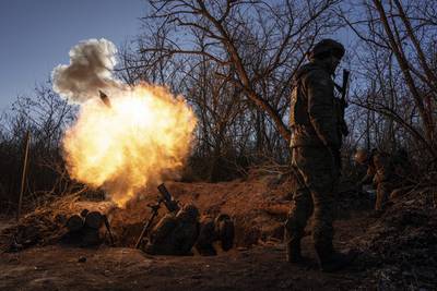 Ukrainian servicemen fire a 120mm mortar towards Russian positions at the frontline near Bakhmut, Donetsk region, Ukraine, Wednesday, Jan. 11, 2023.