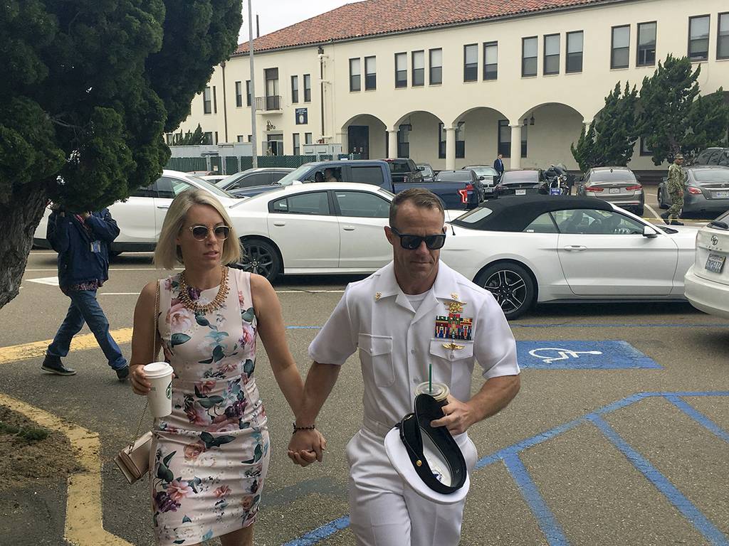 Navy Special Operations Chief Edward Gallagher, right, walks with his wife, Andrea Gallagher, as they arrive to military court on Naval Base San Diego, Thursday, June 20, 2019, in San Diego.