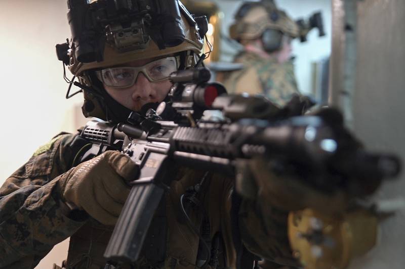 A force reconnaissance Marine provides security while clearing the ship June 29, 2019, during a visit, board, search and seizure exercise aboard the amphibious dock landing ship USS Ashland.