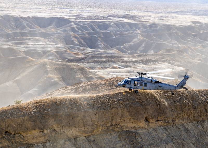 An MH-60S Sea Hawk helicopter stationed in San Diego practices terrain flight tactical landings on Oct. 1, 2020, during Helicopter Advanced Readiness Program (HARP) training at Naval Air Facility El Centro, Calif.