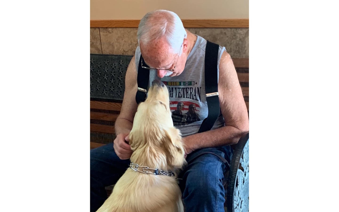 A veteran sits with his service dog.