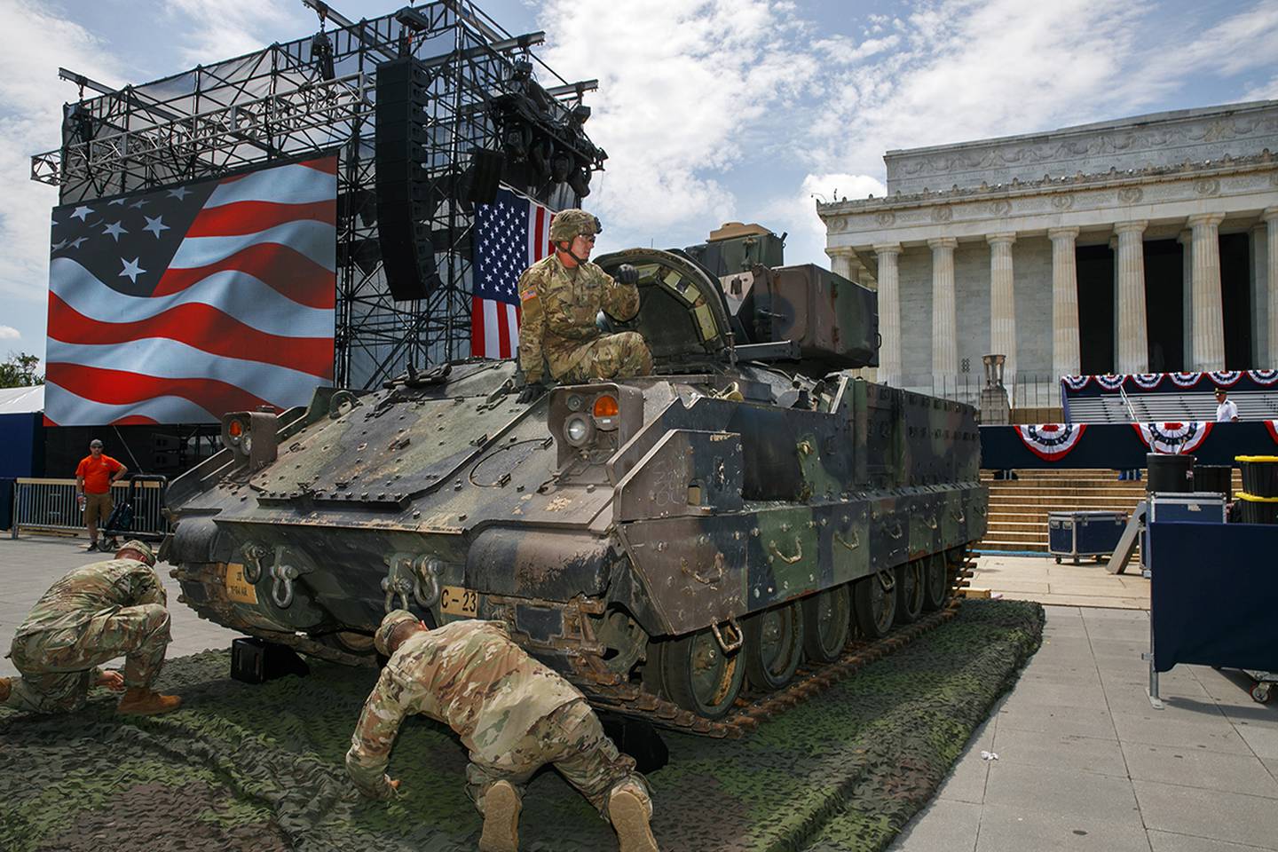 An Army soldier hops out of a Bradley Fighting Vehicle after moving it into place by the Lincoln Memorial, Wednesday, July 3, 2019, in Washington, ahead of planned Fourth of July festivities with President Donald Trump.