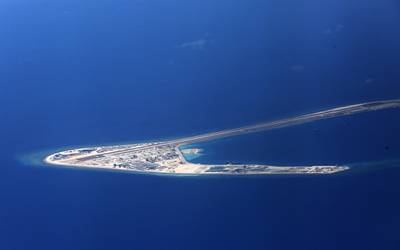 In this April 21, 2017, file photo, Chinese structures and an airstrip on the man-made Subi Reef at the Spratlys group of islands are seen from a Philippine Air Force C-130 transport plane off the disputed South China Sea in western Philippines.