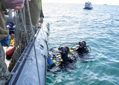 Sailors conduct pre-dive checks during recovery efforts of a high altitude balloon in the Atlantic Ocean, Feb. 7, 2023.
