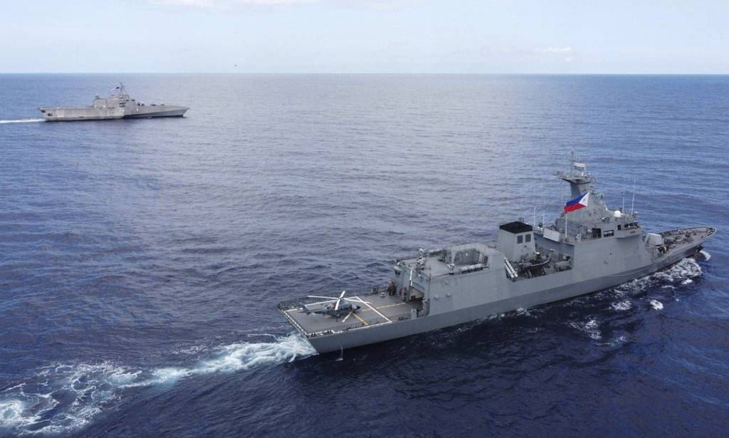 In this handout photo released by Armed Forces of the Philippines, Philippines BRP Jose Rizal, right, and USS Gabrielle Giffords during a tactical exercise between Philippines and the United States in the West Philippine Sea on Thursday Nov. 23, 2023.