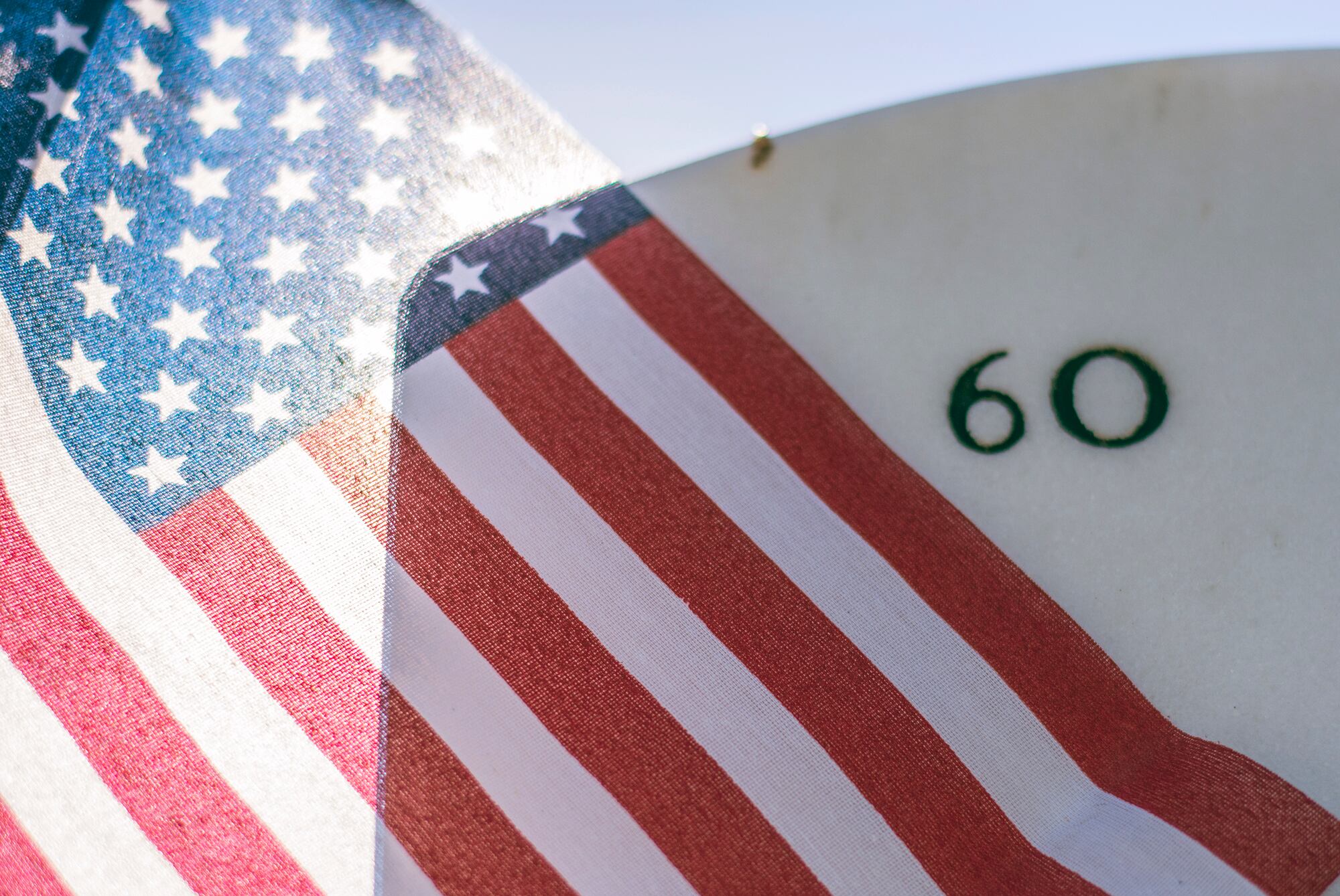 An American flag blows across the back of a tombstone in Section 60 of Arlington National Cemetery, July 22, 2015. Section 60 is the final resting place for those who gave the ultimate sacrifice in America's most recent wars, especially Iraq and Afghanistan.
