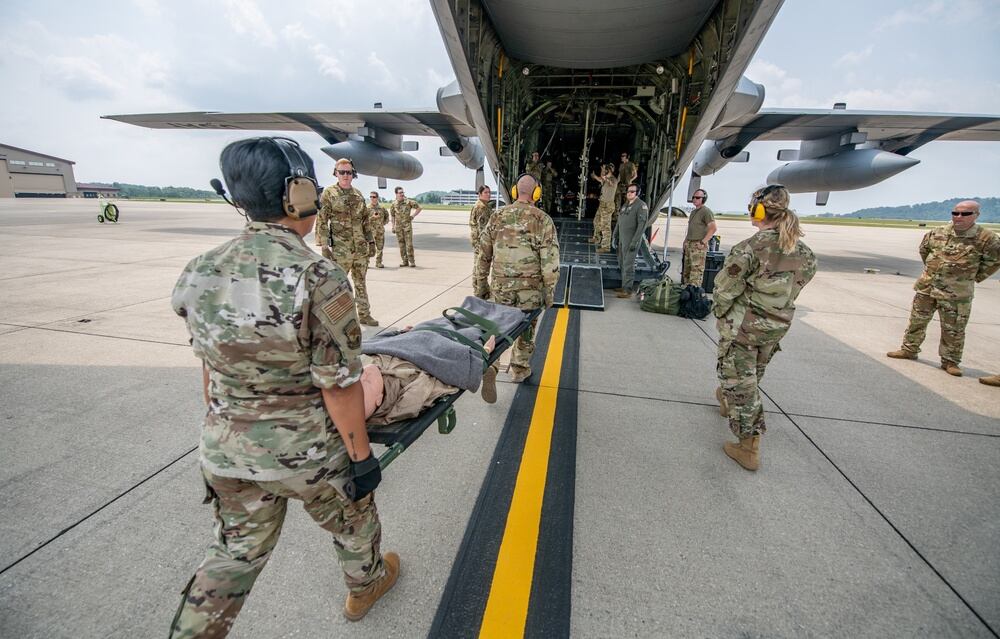 Members of the 130th Airlift Wing perform aeromedical evacuation drills as part of the week-long joint training exercise Sentry Storm at McLaughlin Air National Guard Base in Charleston, West Virginia, July 21, 2021. (Edwin L. Wriston/Army National Guard)