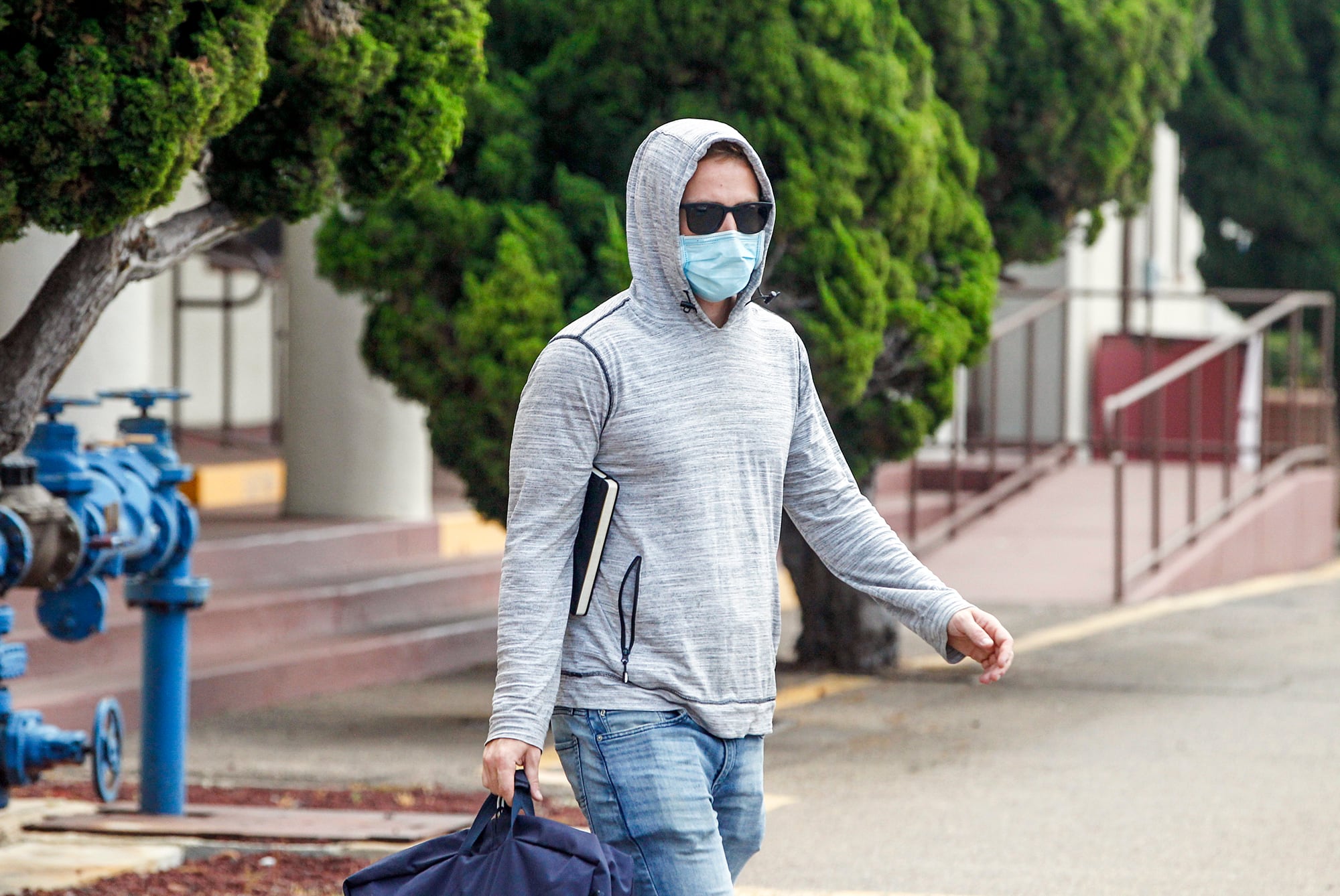 Petty Officer First Class Adel Enayat leaves the building after appearing for a hearing at Naval Base San Diego, Friday, Aug. 21, 2020, in San Diego.