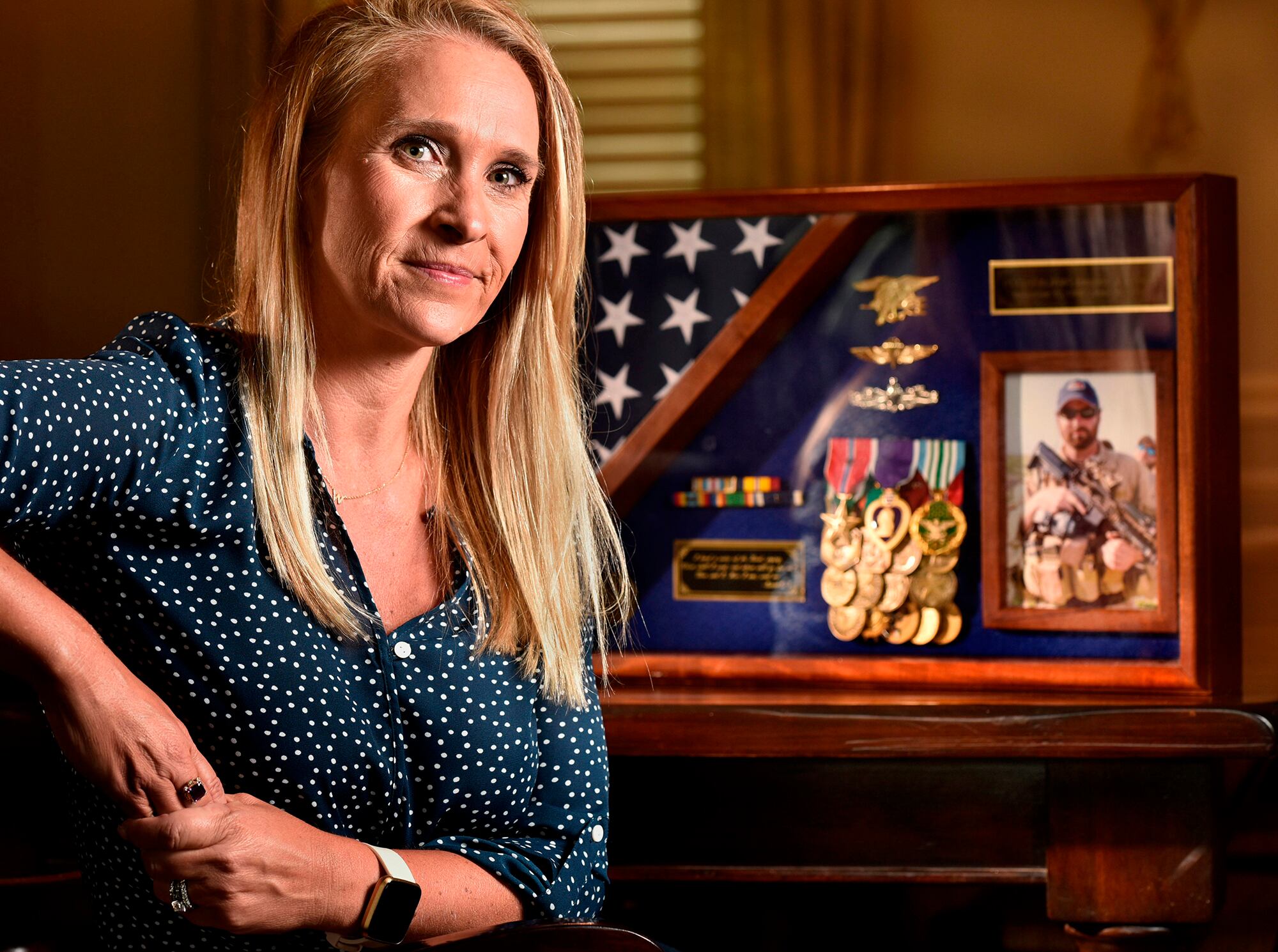 Char Fontan Westfall poses with a memorial of her late husband Jacques Fontan, at her home on June 25, 2020, in St. Johns, Fla.