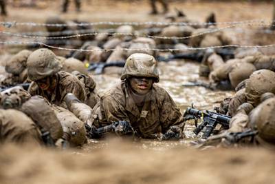 Recruits with November Company, 4th Recruit Training Battalion, work together to move as a fire team through events during the Crucible on Marine Corps Recruit Depot Parris Island, S.C., Dec 3, 2020.