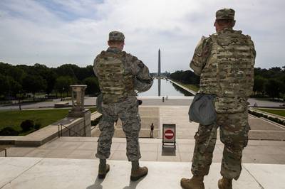 Members of the District of Columbia Army National Guard stand guard at the Lincoln Memorial in Washington, Wednesday, June 3, 2020, securing the area as protests continue following the death of George Floyd, a who died after being restrained by Minneapolis police officers.