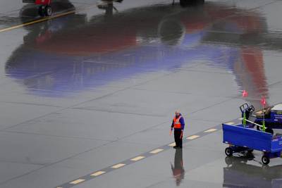 A Southwest Airlines ground operations crew member waits to guide an arriving jet into a gate, Wednesday, Dec. 28, 2022, at Sky Harbor International Airport in Phoenix.