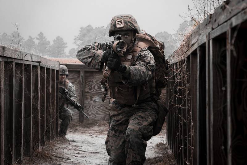 A Marine with 8th Engineer Support Battalion clears a simulated enemy cache site during a simulated live-fire event during Command Post Exercise VI (CPX) on Camp Lejeune, N.C., Feb. 2, 2021.
