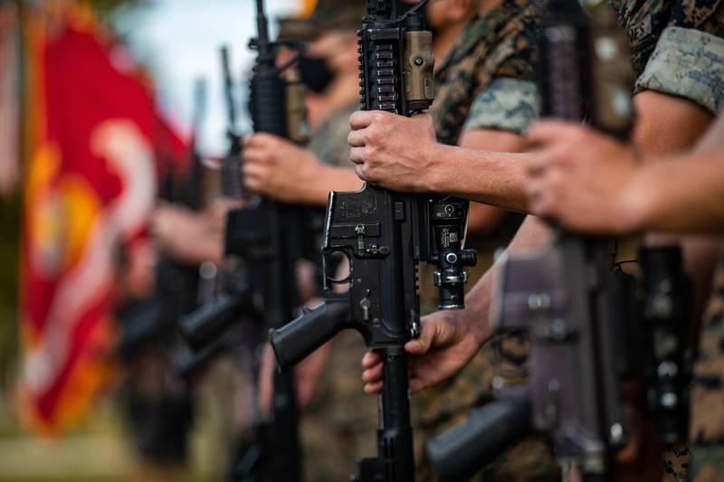 U.S. Marines present arms during a change-of-command ceremony on Camp Lejeune, N.C., Aug. 6, 2020.